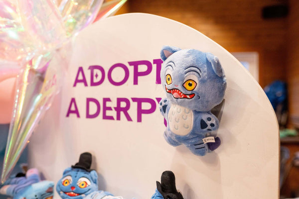 An adopt a derpy party favor station with plushies for a kpop demon hunters birthday party for tweens or kids.