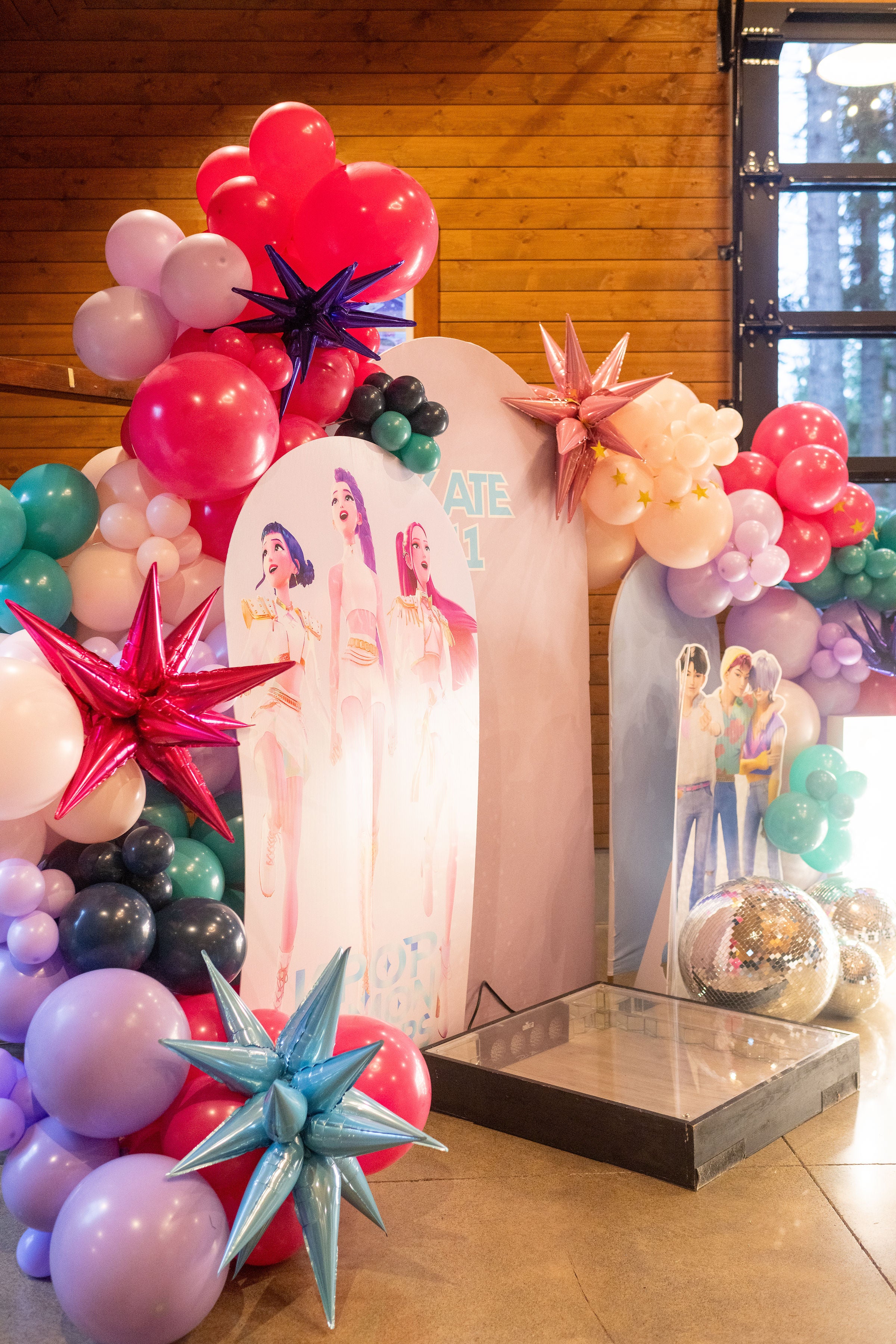 Tween party inspiration and decor featuring Kpop demon hunters party background balloon garland that can be used as a photo backdrop.