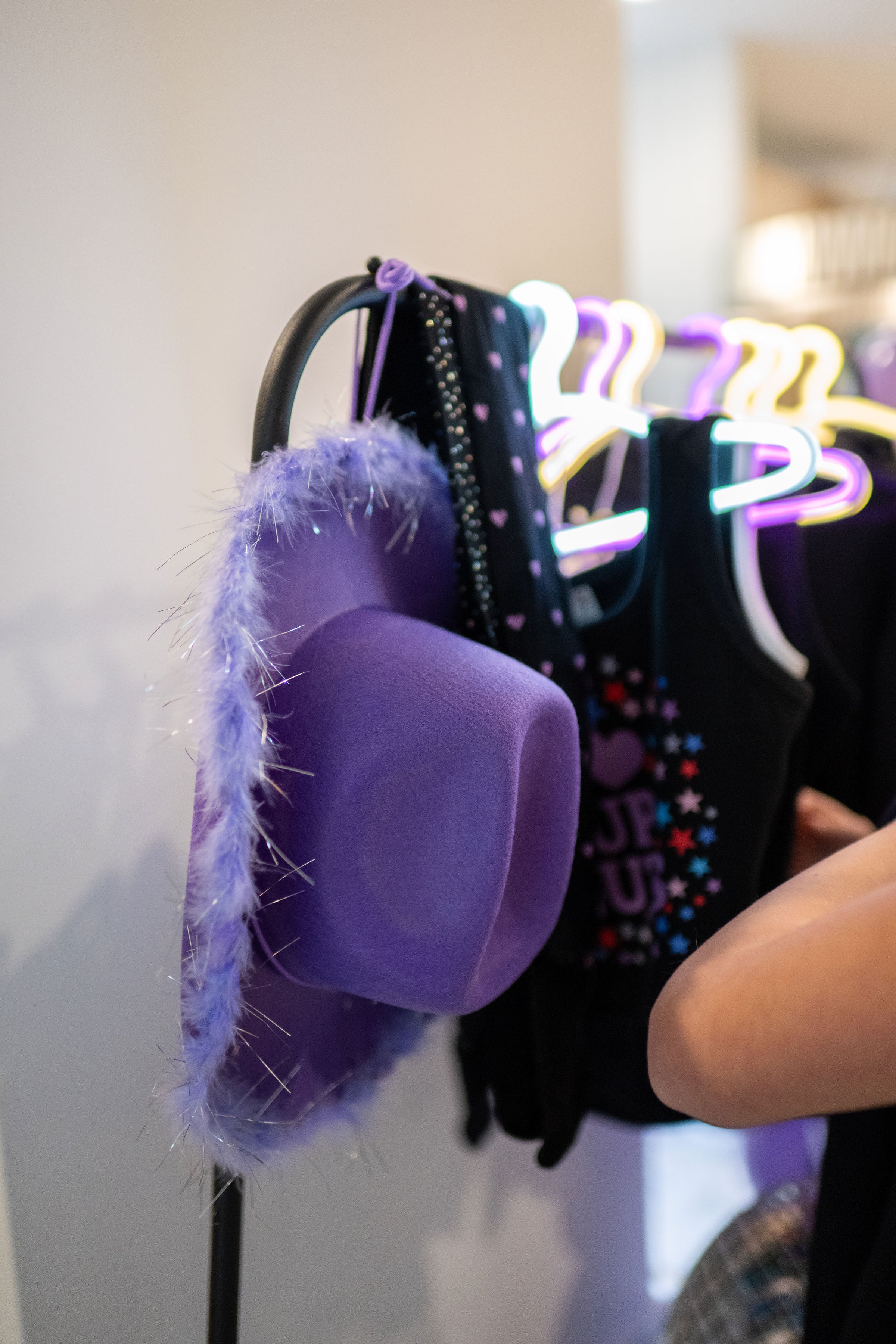 Olivia Rodrigo birthday party inspiration featuring a Guts birthday party detail shot with a purple cowgirl hat party favor for a tween birthday party idea.
