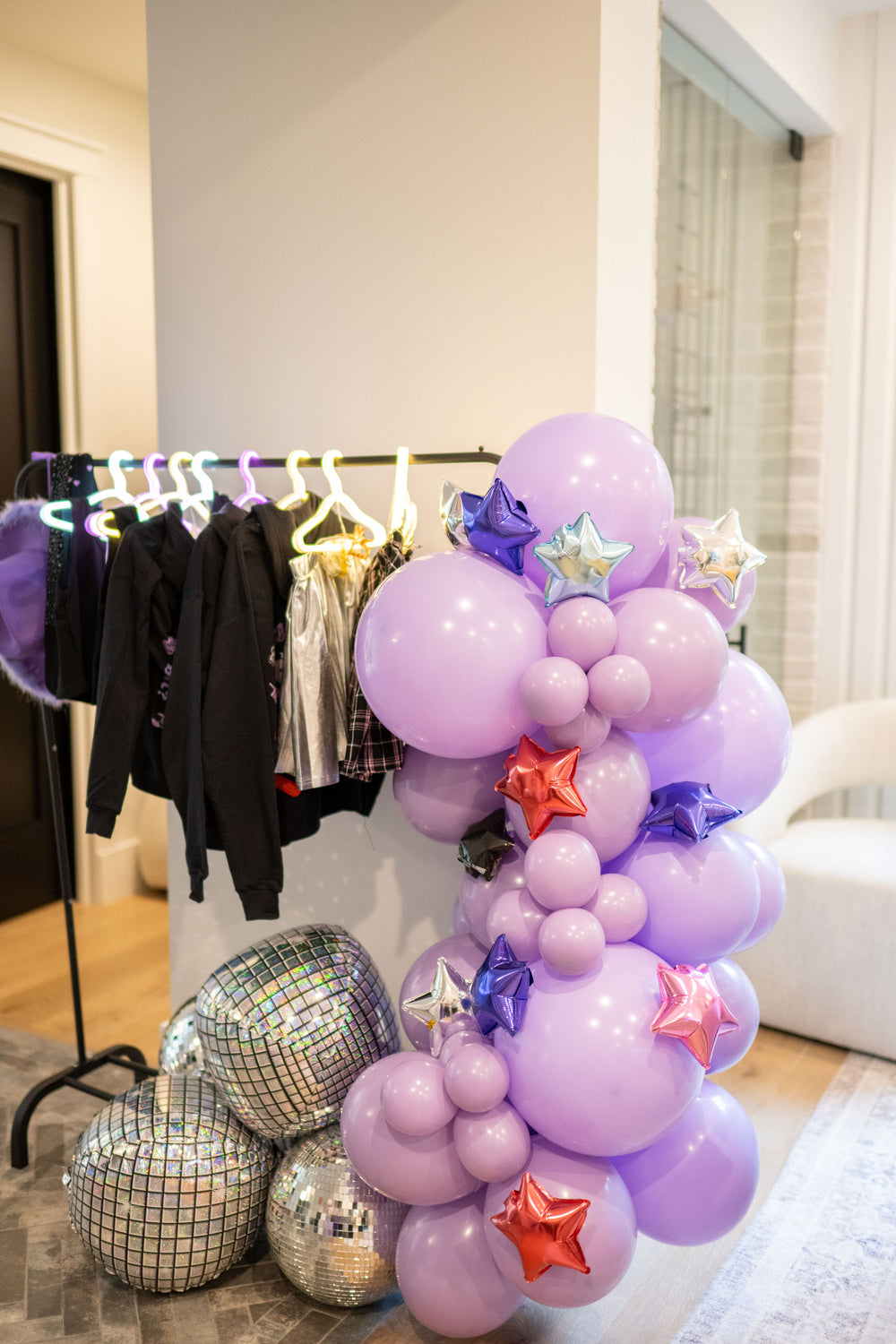 Olivia Rodrigo grab and go balloon garland kit for a GUTS birthday party with metallic multicolor mini star balloons and silver foil disco ball balloons.