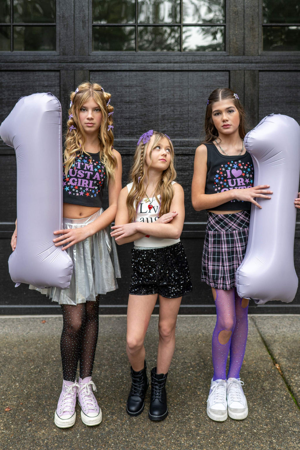Balloon number decorations for an eleventh birthday party with an Olivia Rodrigo Guts theme for tweens.