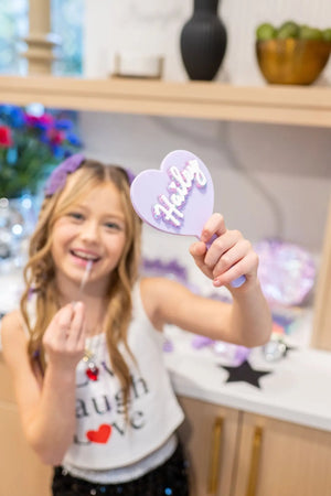 A Custom purple Heart Hand Mirror party favor for an Olivia Rodrigo Guts birthday party for tweens.