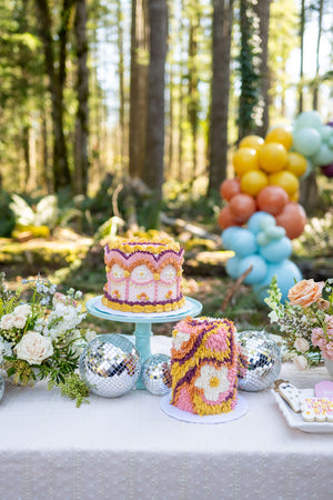 Cake table decoration ideas for a Taylor Swift tea party or rustic glam garden party for tweens or teens, or a bridal shower theme idea for Swifties with a multicolor balloon arch kit and disco ball party decorations.