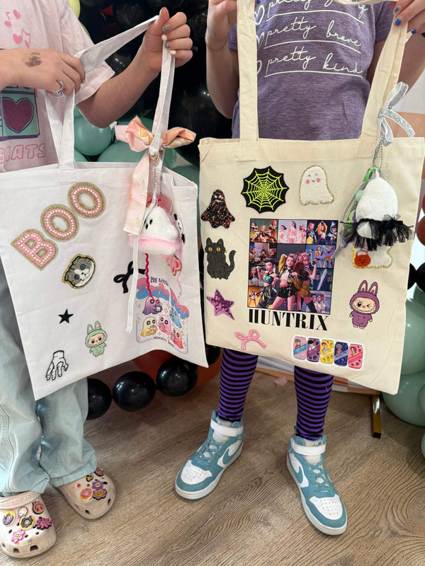 A decorate your own book bag patch bar kit for a Kpop Demon Hunters birthday party with Huntrix patches and halloween patches.