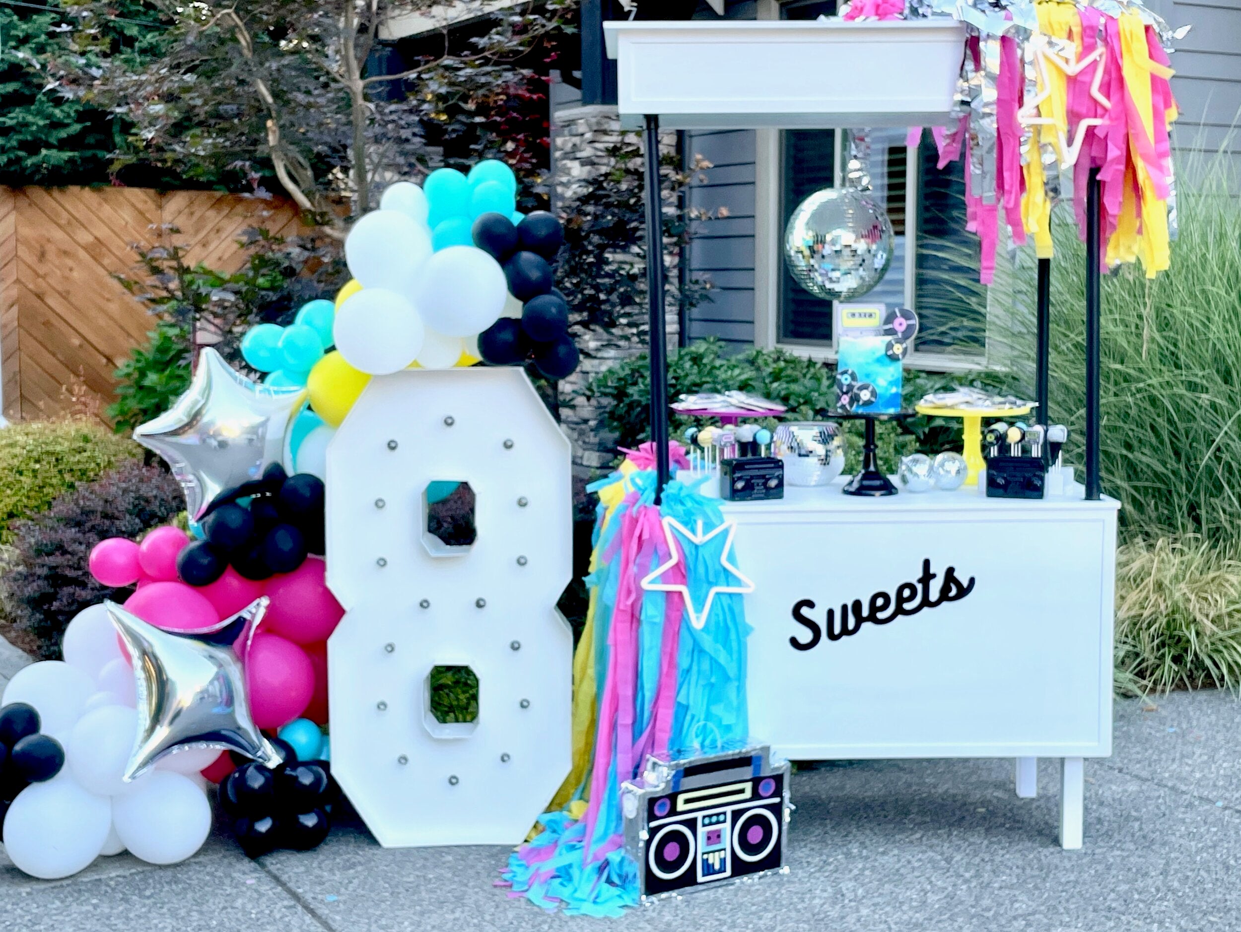 Party inspiration for a disco dance party birthday theme for teens, kids, tweens, or adults with 80s decor and a DIY balloon garland kit.