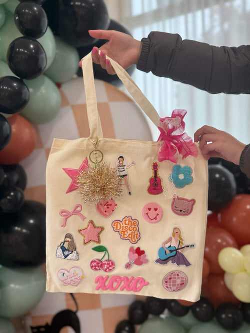 A decorate your own book bag party favor or party activity idea for a tween, teen, or kids birthday party for girls with a Taylor Swift patch bar kit.