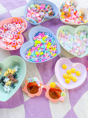 A charm bar party activity or party favor idea with a decorate your own sunglasses kit for a tween or kids girls birthday party.