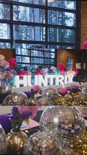 A video compilation of Kpop demon hunters party inspiration for a tween or kids birthday party with custom marquee letters, a balloon garland photo backdrop, a soda cart, and kpop demon hunters plushie party favors.