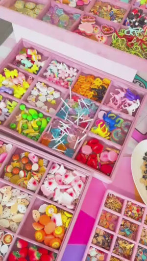 A charm bar party activity or party favor idea with DIY customizable charms for tweens or kids to make personalized keychains, bracelets, or tennis shoe charms. 