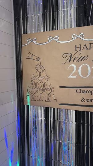 Silver tinsel backdrop for a new years eve party decoration idea.