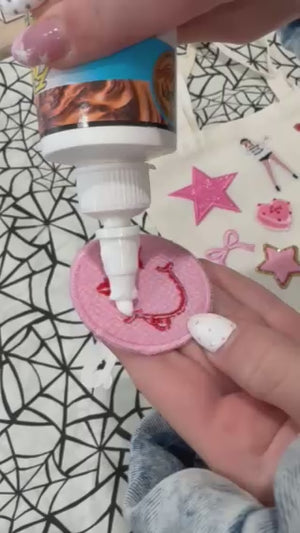 A decorate your own book bag party favor or party activity idea for a tween, teen, or kids birthday party for girls with a Taylor Swift patch bar kit.